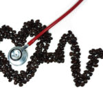 stethoscope on cardiogram line forming heart made from coffee be